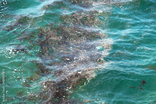 Rubbish and debris floating on the Cantabrian sea (Atlantic Ocean) of Riazor beach in A Coruña, Spain.