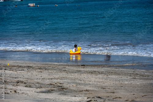 happy hispanic children play on the sandy shore near the sea 