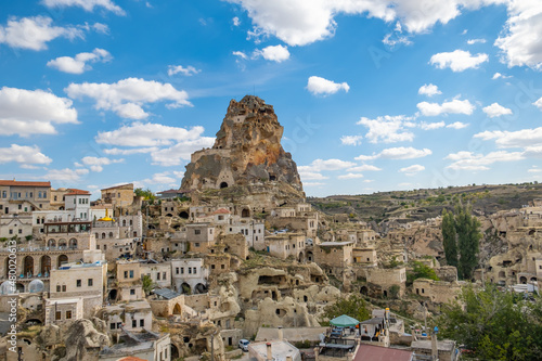 Ortahisar castle or central castle and fairy chimneys in Cappadocia, Turkey. Ortahisar Castle and traditional houses carved stone. Cave houses in fairy chimneys.