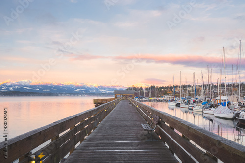 Sunset or sunrise at the waterfront boardwalk and marina on a cold winter day at Comox Harbour, British Columbia, Canada.