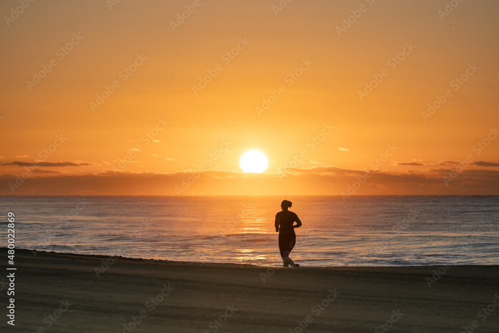 Sunrise in Meloeras, Gran Canaria with jogger on the beach