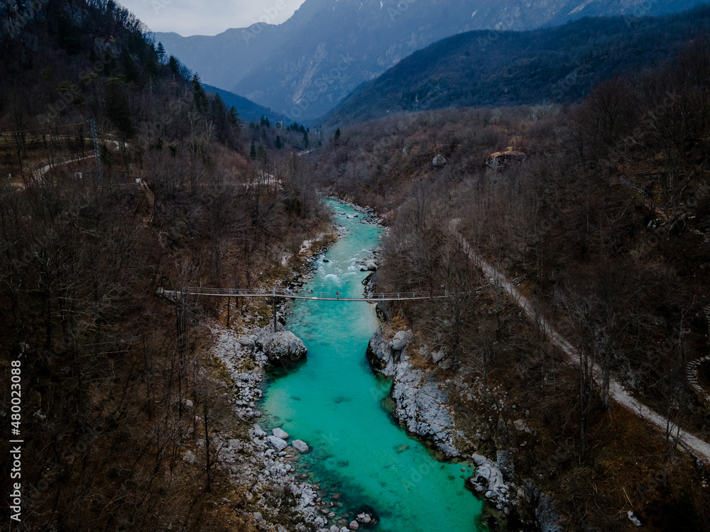 Turquoise Soca River near Kozjak falls, julian alps in the background