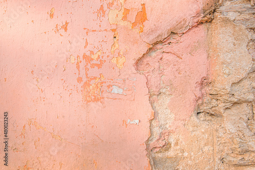 Distressed pink old brick wall. Background with painted peeling plaster. Abstract grunge wall. Abstract plastered wall web banner. Design element.