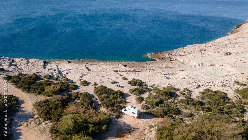 White camper, rv, motorhome standing at a beach camp spot, Vis Island, Croatia White camper, rv, motorhome standing at a beach camp spot, Vis Island, Croatia