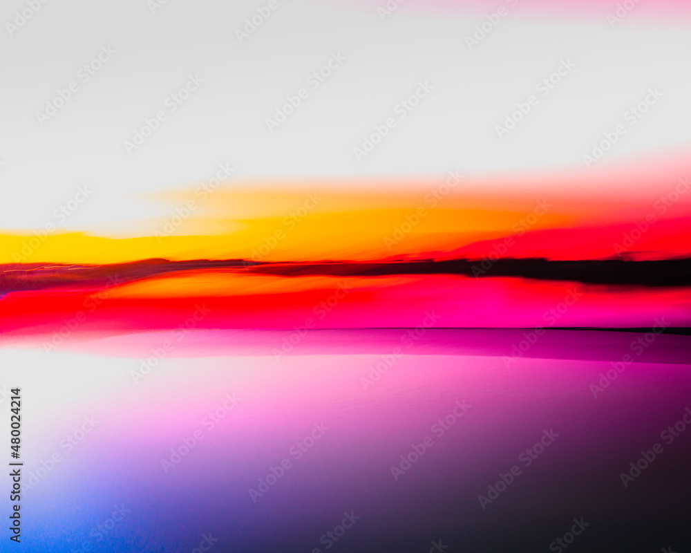 Vibrant saturated seascape in red, pink, orange, blue, purple, and black colors. Motion blur photography of Atlantic Ocean at sunrise.