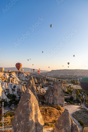 GOREME, TURKEY - AUGUST 20, 2021: Hot air balloons flying in Cappadocia at morning