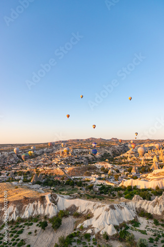 GOREME, TURKEY - AUGUST 20, 2021: Hot air balloons flying in Cappadocia at morning