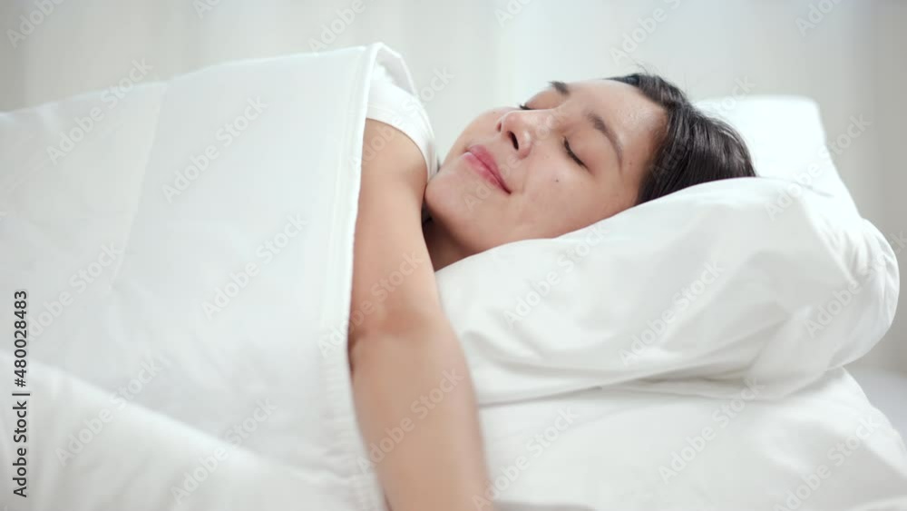 Beautiful asian woman lying asleep enjoying healthy good sleep nap in the morning. Young woman sleeping well in comfortable cozy fresh bed on soft pillow white linen. Beautiful asian woman lying asleep enjoying healthy good sleep nap in the morning. Young woman sleeping well in comfortable cozy fresh bed on soft pillow white linen.
