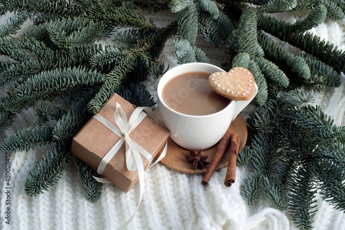 a cup of cocoa, cookies, a gift box and spruce branches. congratulations on valentine's day, march 8, gift to mom, romantic background.