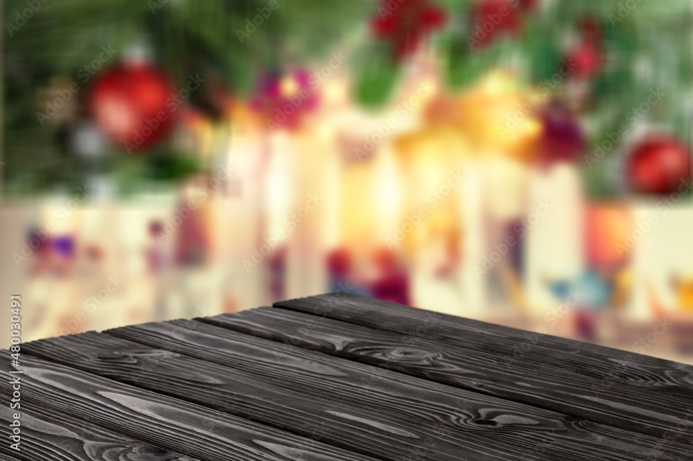 Fototapeta premium Wooden table with bokeh Christmas background of abstract in front of coffee shop or restaurant or montage.