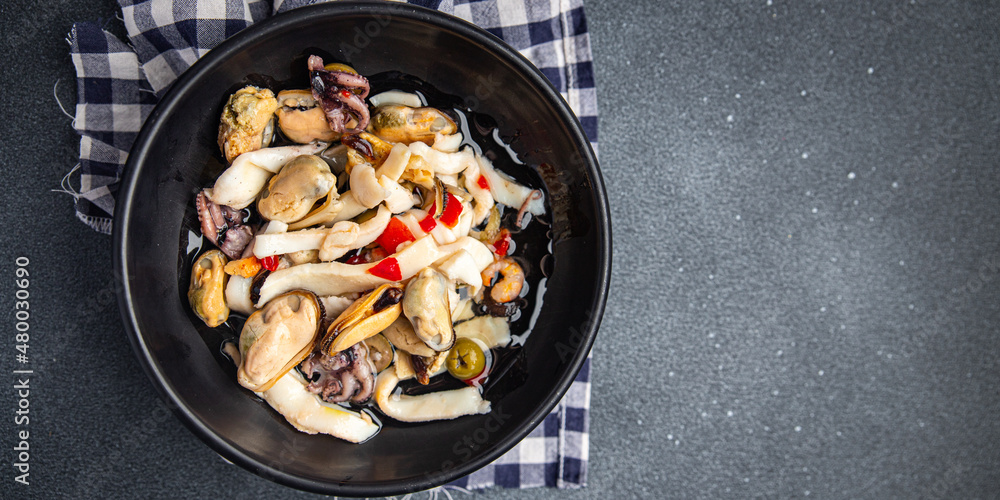 seafood salad mussels, squid, octopus, shrimps meal food snack on the table copy space food background seafood salad mussels, squid, octopus, shrimps meal food snack on the table copy space food background