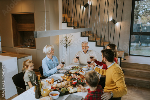 Happy family having dinner ...