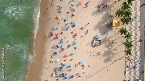 Rio de Janeiro, Brazil, top down aerial view of waves breaking on the shore of famous Copacabana beach during summer.  photo