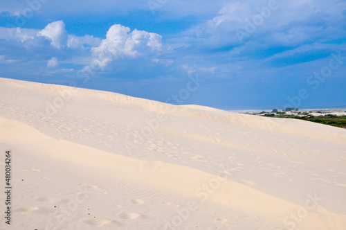View of dunes with blue sky and clouds in the background in Araranguá , Santa Catarina