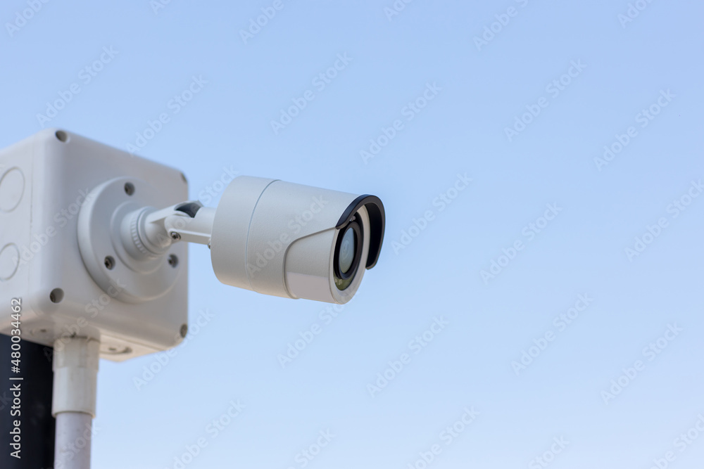 Security CCTV camera surveillance system outdoor of house. A blurred night city scape background. Modern CCTV camera on a wall. Equipment system service for safety life or asset. Security CCTV camera surveillance system outdoor of house. A blurred night city scape background. Modern CCTV camera on a wall. Equipment system service for safety life or asset.