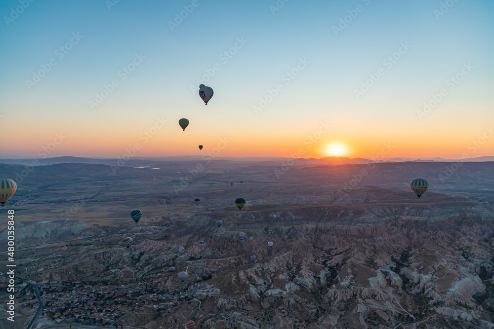 GOREME, TURKEY - AUGUST 20, 2021: Hot air balloons flying in Cappadocia at morning GOREME, TURKEY - AUGUST 20, 2021: Hot air balloons flying in Cappadocia at morning