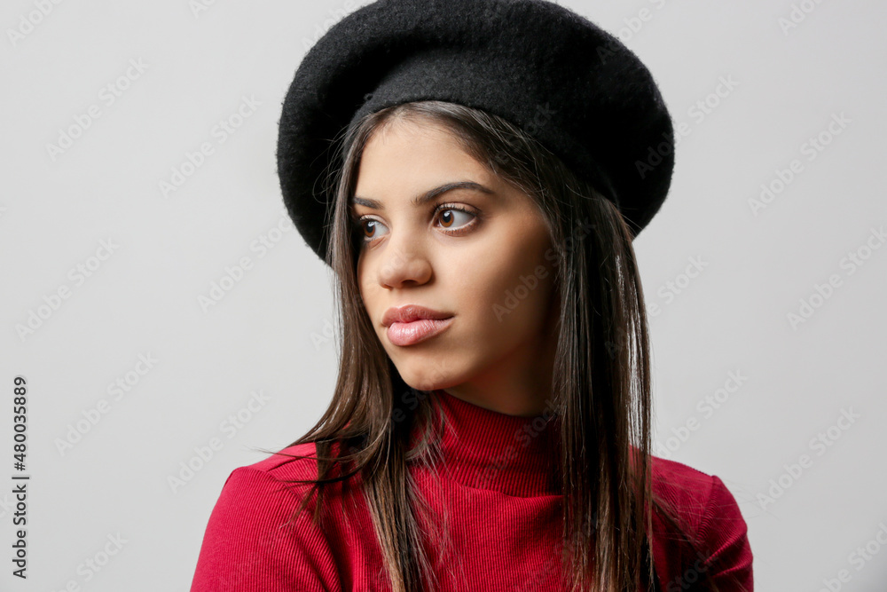 Portrait of attractive young woman in red dress and black beret. Portrait of attractive young woman in red dress and black beret.