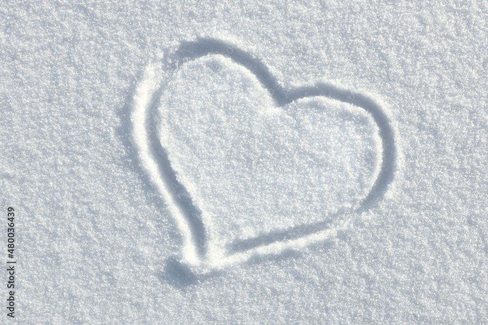 hand drawn heart on white fresh snow, concept of love for winter snow season and valentines day natural outdoors background hand drawn heart on white fresh snow, concept of love for winter snow season and valentines day natural outdoors background