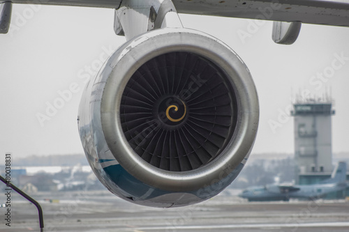 Airplane jet engine, daytime photo against the background of a cloudy sky