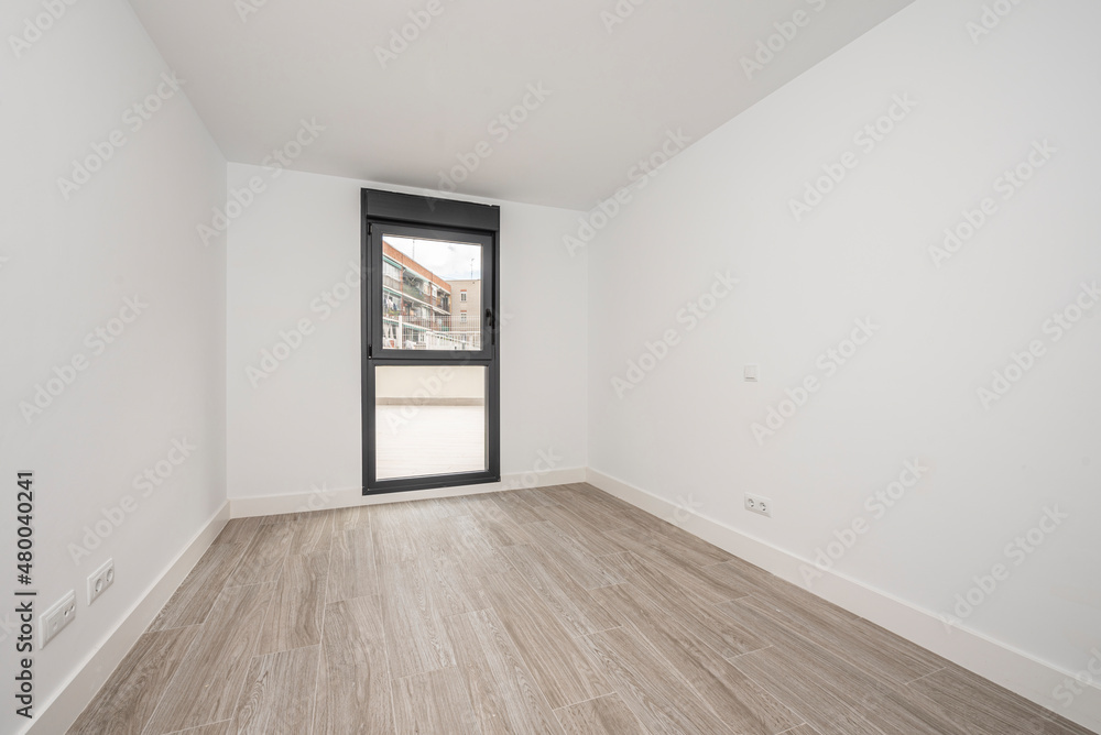 Newly painted empty room with floor to ceiling window Newly painted empty room with floor to ceiling window