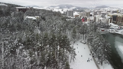 Mountain resort Zlatibor, Serbia, in winter, with kids playing on the snow photo