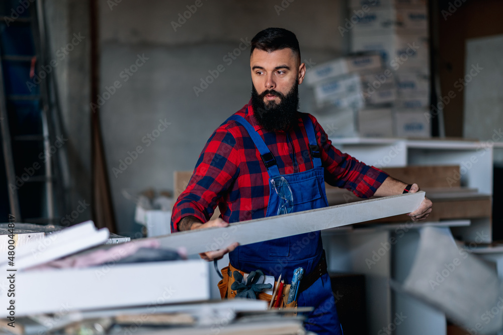 Young male carpenter working in workshop Young male carpenter working in workshop