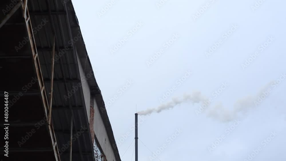 Boiler room flue pipe. Large chimney of an industrial plant from which smoke comes out. Pollution of the atmosphere by chemical plants. Boiler room flue pipe. Large chimney of an industrial plant from which smoke comes out. Pollution of the atmosphere by chemical plants.