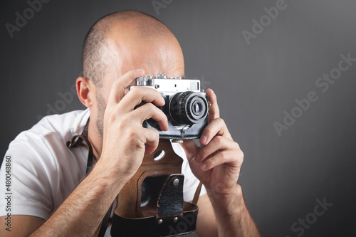  Man taking a picture with old camera.