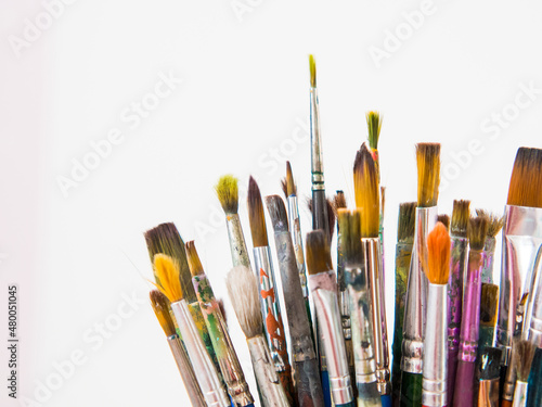 many different brushes for painting, artist's working brushes close-up, copy space