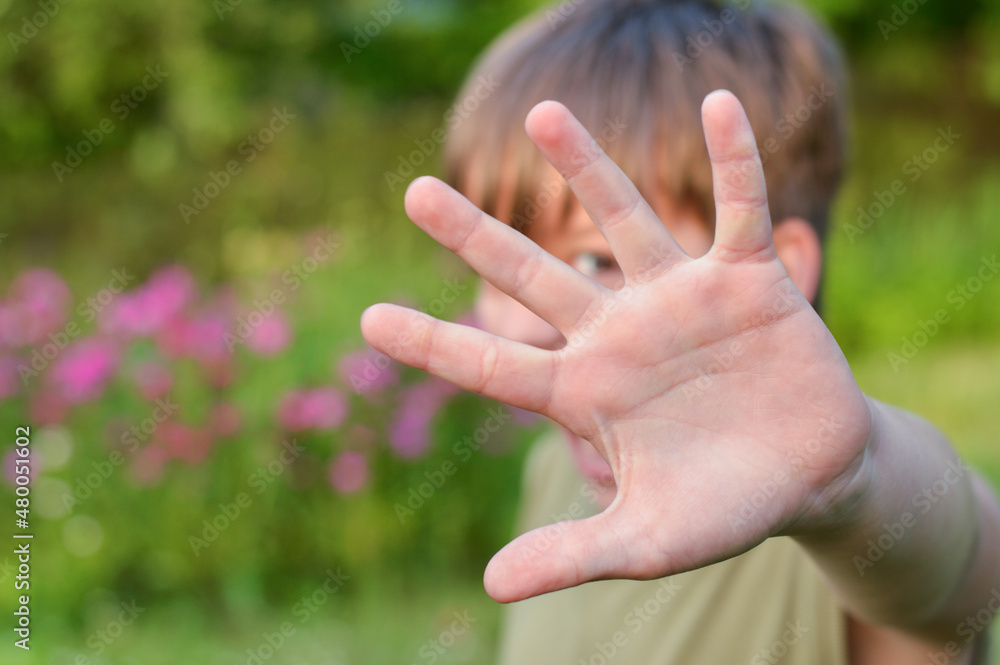 Blurred image of a boy defending himself with his hand.Child abuse, domestic violence. Blurred image of a boy defending himself with his hand.Child abuse, domestic violence.