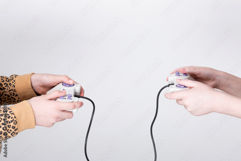 custom made wallpaper toronto digitalClose up photo two little age girls, holding in hands two game joystick, trying hard to win game