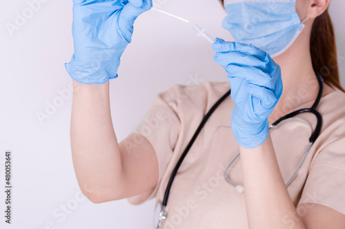 Wallpaper Mural Woman's Doctor's hand in medical gloves holding test tube with coronavirus COVID-19 Torontodigital.ca