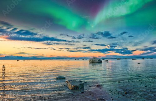 Sunset on the Cook Inlet in Alaska with the Northern Lights Appearing in the Sky over the Mountains
