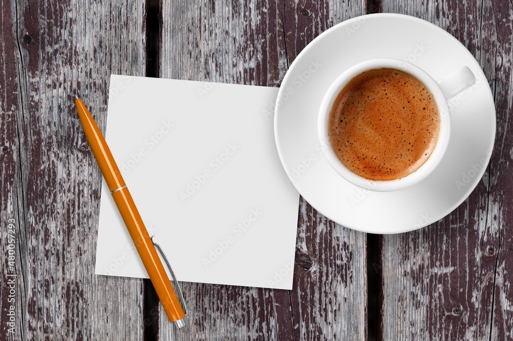 Paper with a cup of coffee, product or business review of the recent year Paper with a cup of coffee, product or business review of the recent year
