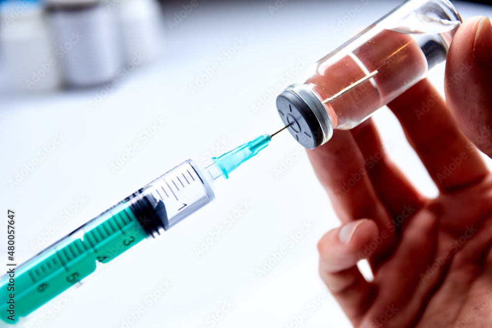Vaccine in vial with syringe Vaccine in vial with syringe