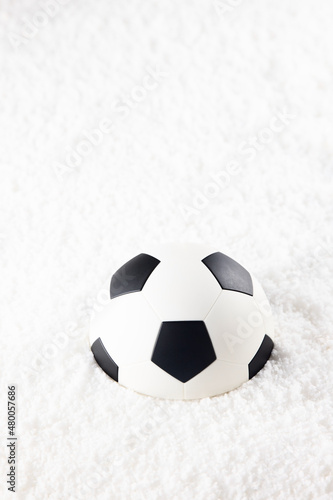 Soccer ball in winter snow powder © Aguus