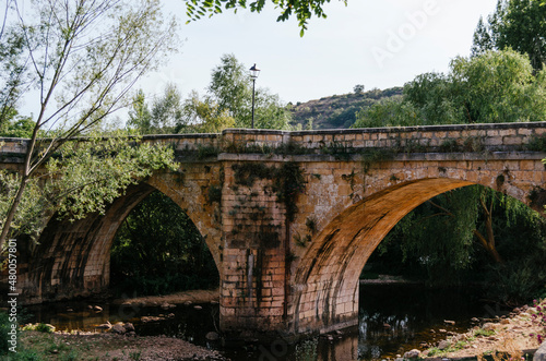 Medieval bridge of San Pablo over the Arlanza river in Covarrubias, Burgos, Castilla y León, Spain. photo