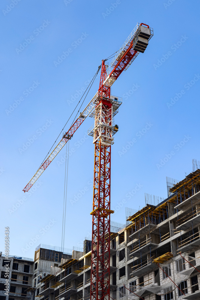 Tower crane on the construction site of the residential building of block flat (apartment) Tower crane on the construction site of the residential building of block flat (apartment)