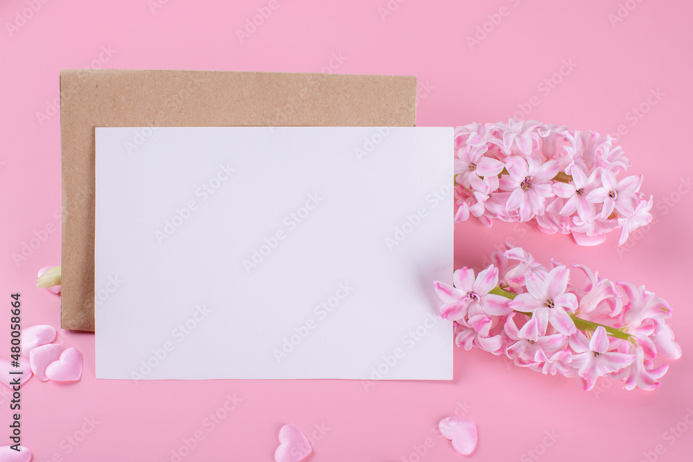 Blank wedding invitation stationery card mockup with envelope on pink background with hyacinth flowers and pink heart, 5x7