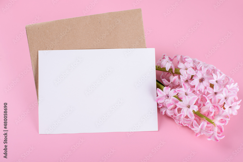 Blank wedding invitation stationery card mockup with envelope on pink background with hyacinth flowers Blank wedding invitation stationery card mockup with envelope on pink background with hyacinth flowers