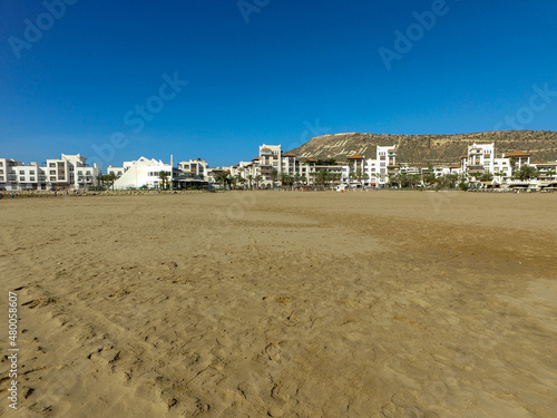 Beach photo taken in Agadir in Morocco in the background you can can see the monument in the hill locally known as Agadir Oufella in the summer time. photo