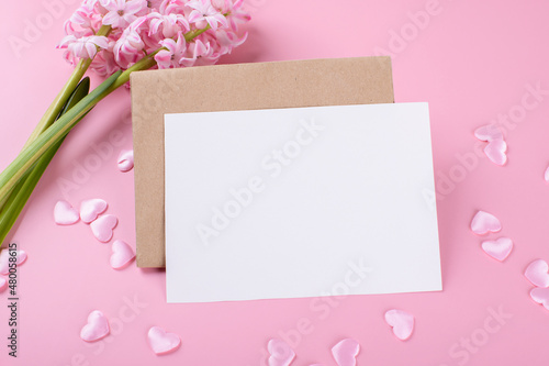 Blank wedding invitation stationery card mockup with envelope on pink background with hyacinth flowers and pink hearts, 5x7 ratio
