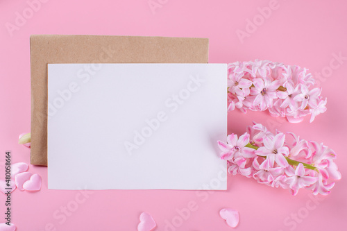 Blank wedding invitation stationery card mockup with envelope on pink background with hyacinth flowers and pink heart, 5x7 © Anna Fedorova