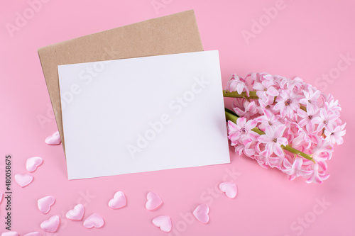 Blank wedding invitation stationery card mockup with envelope on pink background with hyacinth flowers and pink hearts, feminine blog. Valentines day card, valentines day background, mothers day © Anna Fedorova