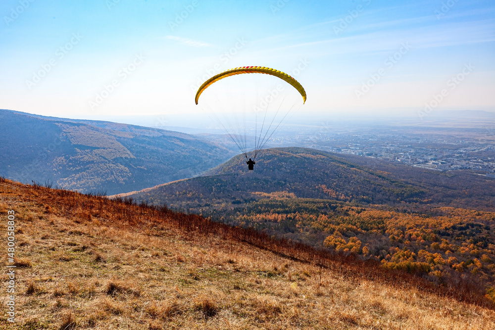 Paragliding over hills and autumn forest Paragliding over hills and autumn forest