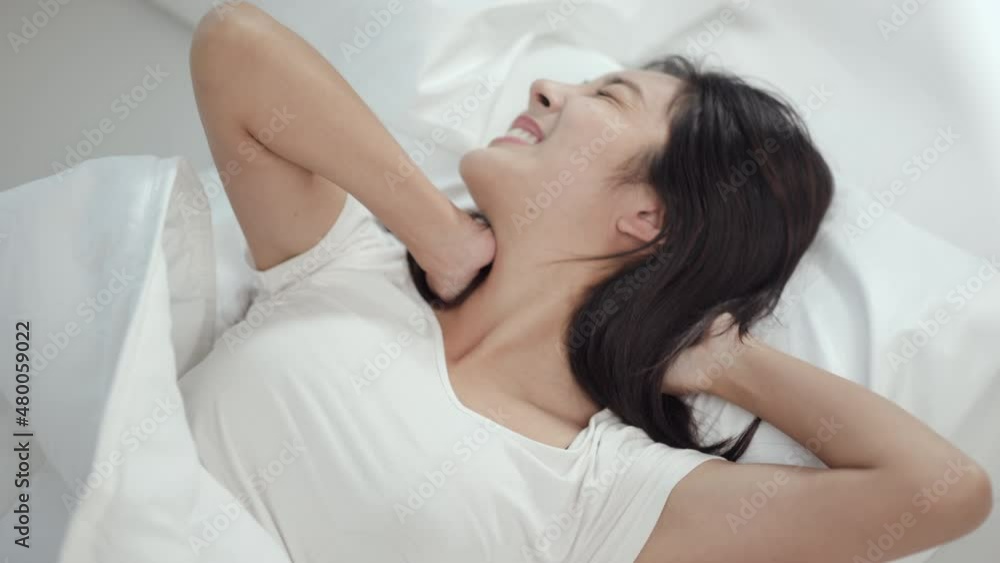 Young woman wake up before lying asleep enjoying healthy in the morning. Beautiful asian woman be awake well in comfortable cozy fresh bed on soft pillow white linen. Young woman wake up before lying asleep enjoying healthy in the morning. Beautiful asian woman be awake well in comfortable cozy fresh bed on soft pillow white linen.