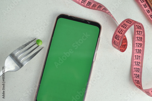 Smartphone with green screen and fresh vegetables copy space photo