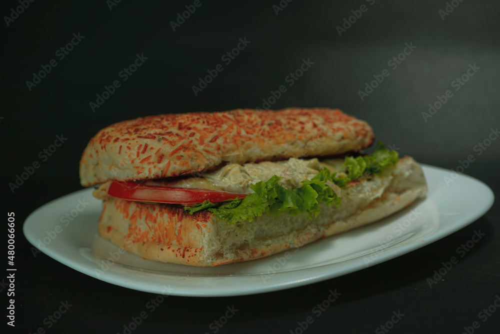 Delicious chicken sandwich on black background Delicious chicken sandwich on black background