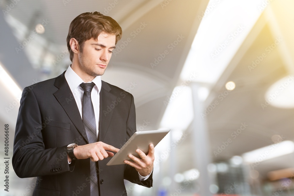 Smiling Young Man With Digital Tablet In Hands Posing At Airport Terminal, Smiling Young Man With Digital Tablet In Hands Posing At Airport Terminal,