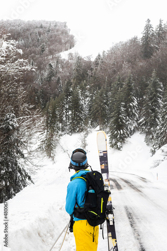 Young caucasian skier inside a snowy forest on the Pyrenees.